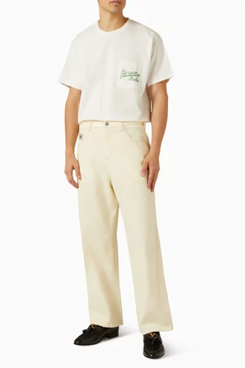 تي شيرت بشعار Geneva مطرز بخرز على الجيب قطن