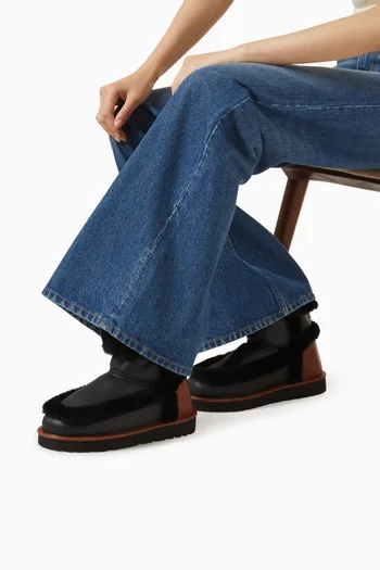 حذاء بوت دولسي بطول الكاحل فرو وجلد عجل بارز الملمس