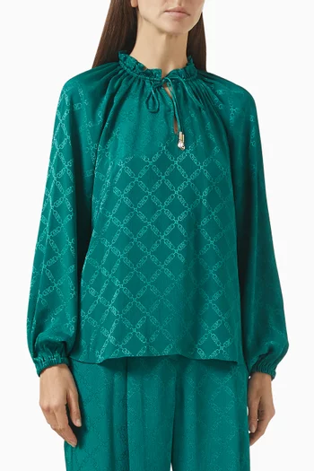 بلوزة بأكمام رغلان ونقشة شعار الماركة جاكار