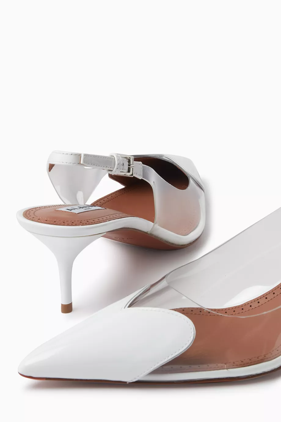 Buy Alaïa White Heart 55 Slingback Mules in Patent Leather For